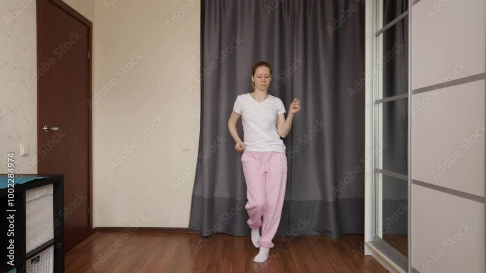 Woman dancing at home, engaged in online dance education, young girl having fun in a relaxed indoor setting. Woman dancing at home, engaged in online dance education, young girl having fun in a relaxed indoor setting.
