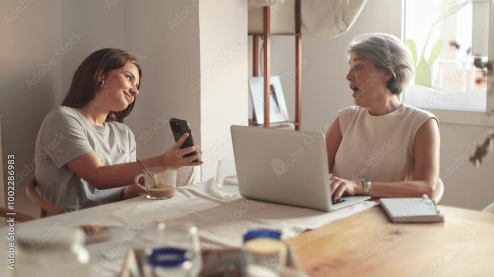 Mother and daughter enjoying a chatty moment with gadgets Mother and daughter enjoying a chatty moment with gadgets