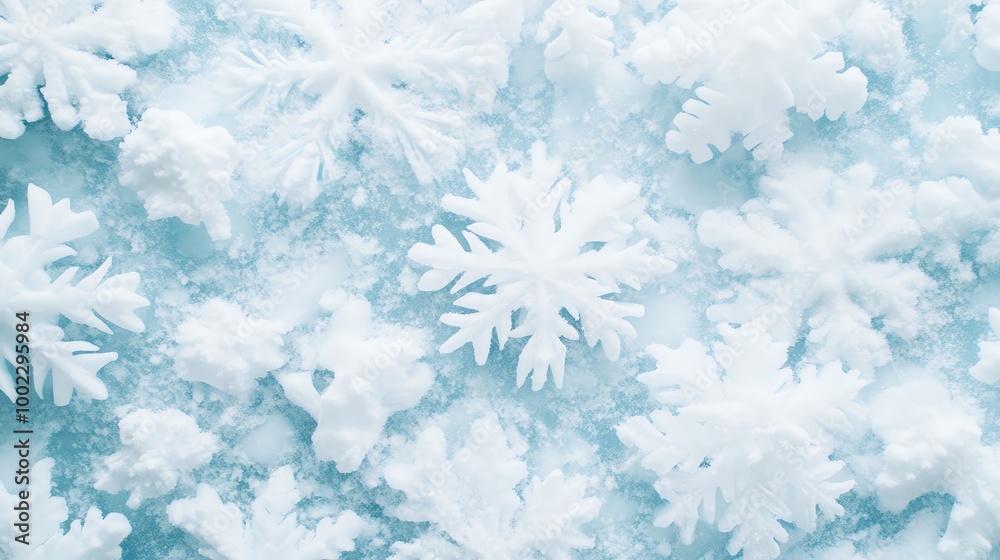 Delicate snowflakes on a soft blue background, creating a serene winter atmosphere. Delicate snowflakes on a soft blue background, creating a serene winter atmosphere.