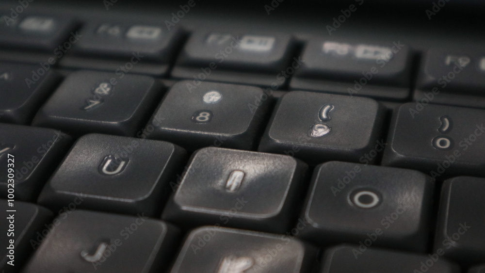 A close up photo of a grey and white office computer keyboard. A close up photo of a grey and white office computer keyboard.