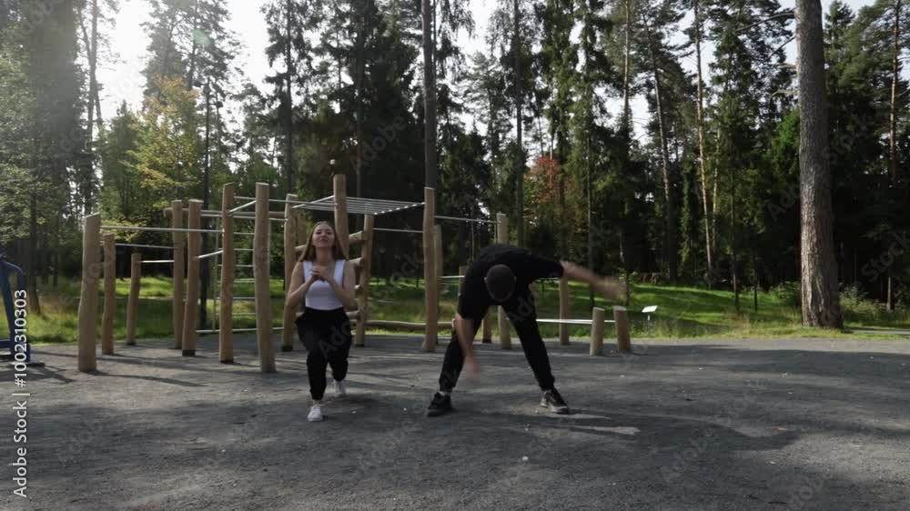 Workout, man and woman doing sports outdoors, sporty exercise on stadium grounds, fitness training outside, athletic people in the park. Workout, man and woman doing sports outdoors, sporty exercise on stadium grounds, fitness training outside, athletic people in the park.