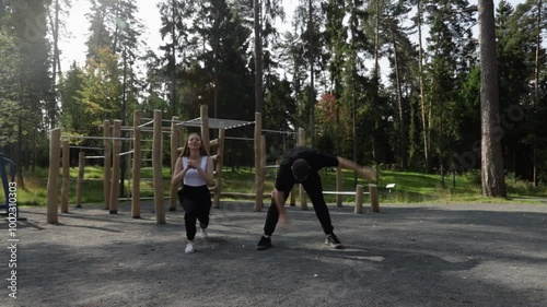 Wallpaper Mural Workout, man and woman doing sports outdoors, sporty exercise on stadium grounds, fitness training outside, athletic people in the park. Torontodigital.ca