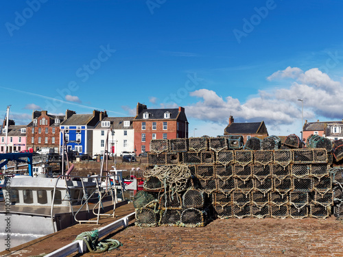 Stacks of Creels for Lobster and Crab Fishing stacked up on the traditional stone and cobbled Quayside of Arbroath Fishing Port.