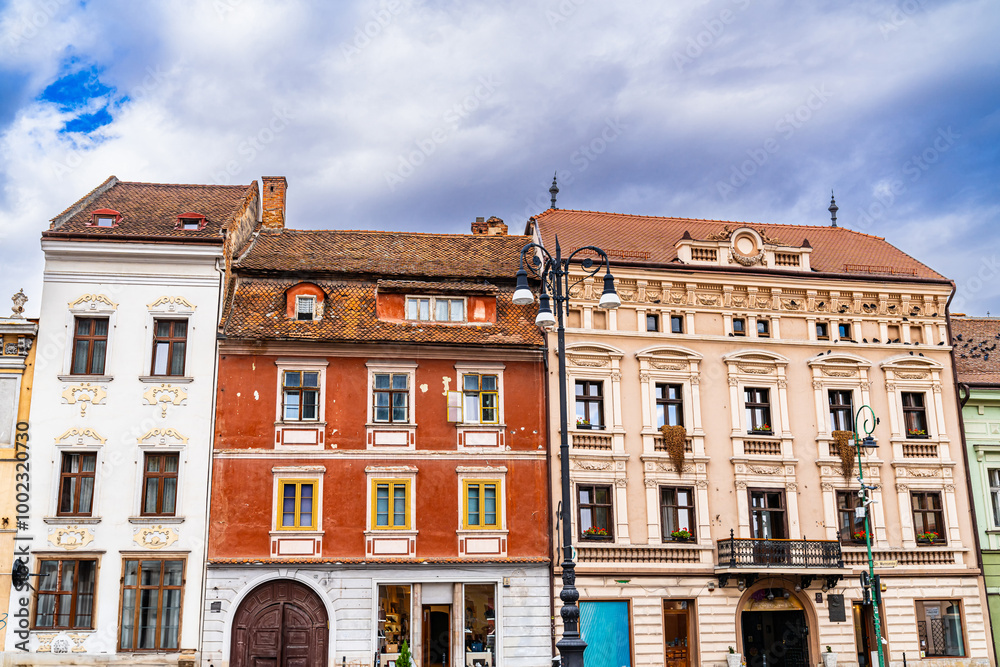 Brasov's historic Romanian architecture. In Brasov, historic structures display unique Romanian architectural styles beneath a cloudy sky, reflecting the city's rich heritage. Brasov's historic Romanian architecture. In Brasov, historic structures display unique Romanian architectural styles beneath a cloudy sky, reflecting the city's rich heritage.