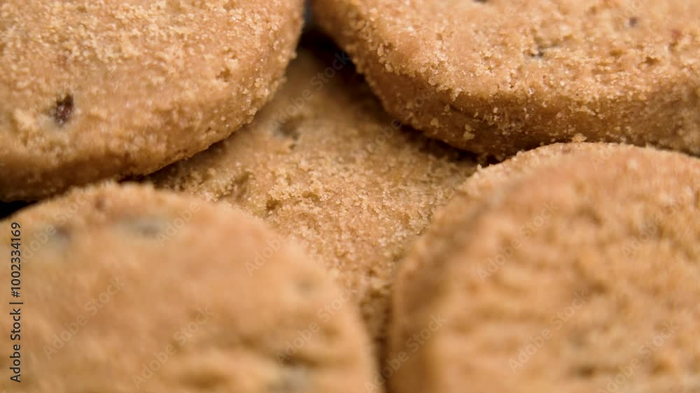 Freshly baked biscuits with golden brown crumbly texture and chocolate pieces. Macro. Rotation Freshly baked biscuits with golden brown crumbly texture and chocolate pieces. Macro. Rotation