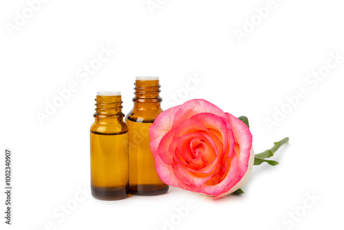 Rose essential oil isolated on white background.Roses and a bottle of rose perfumed water. Aromatherapy treatment. Beauty concept. Spa procedure.Natural organic oil.Anti-stress and detox relax.