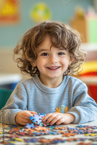 Boy with curly hair enjoying creative playtime with beads