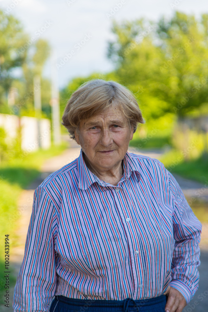 Old woman portrait in the garden. Selective focus. Old woman portrait in the garden. Selective focus.