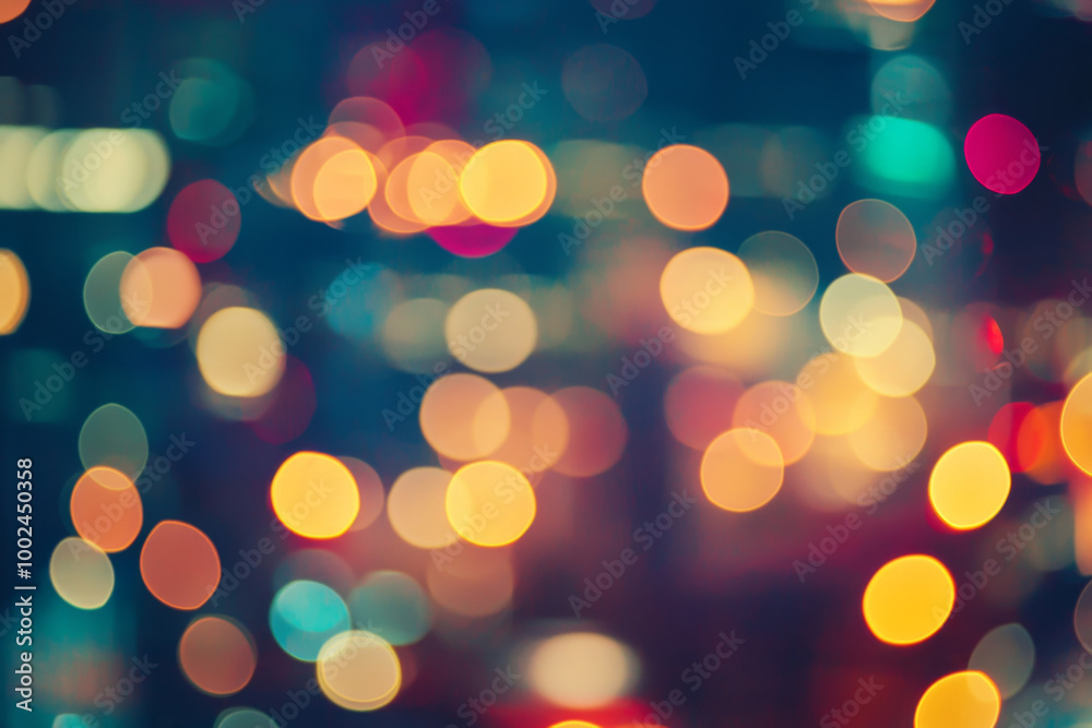 Obraz premium Colorful bokeh lights create a dreamy urban atmosphere at night in a bustling city