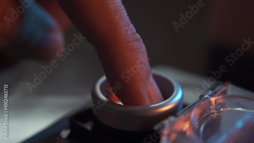 Pushing a red start button with cover