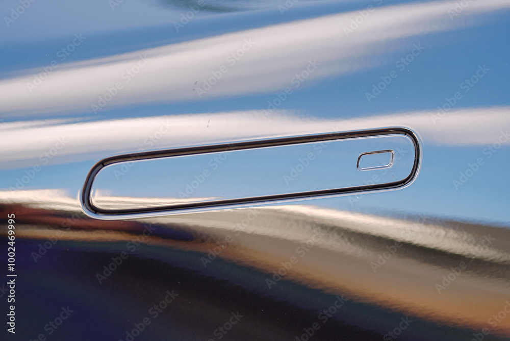 Obraz premium Hidden black car door handle closeup. Minimalistic hidden door handle design on black car, futuristic and smooth door opening system for luxury vehicles. Selective focus