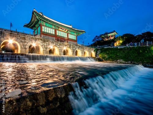 Suwon-si, Gyeonggi-do, South Korea - August 16, 2020: Long exposure photography of night Suwoncheon stream with Banghwasulyujeong Pavilion of Suwon Hwaseong Fortress photo