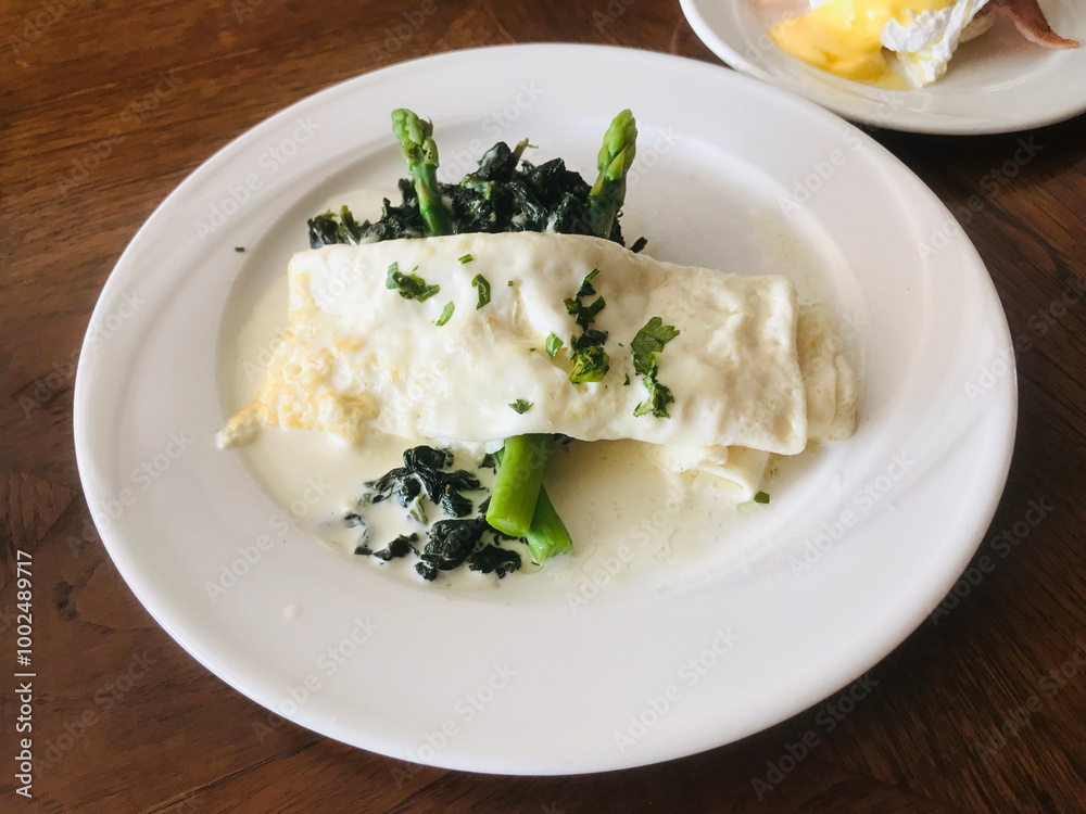 Dish of Egg white omelette served with asparagus. Dish of Egg white omelette served with asparagus.