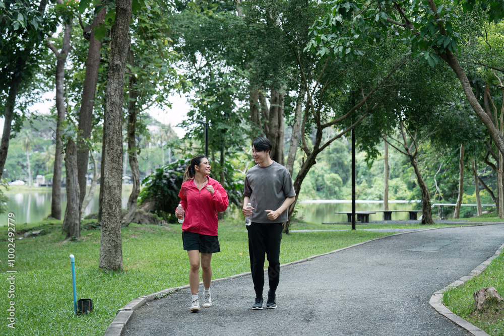 Young Couple Jogging in a Scenic Park for a Healthy Workout Routine Young Couple Jogging in a Scenic Park for a Healthy Workout Routine