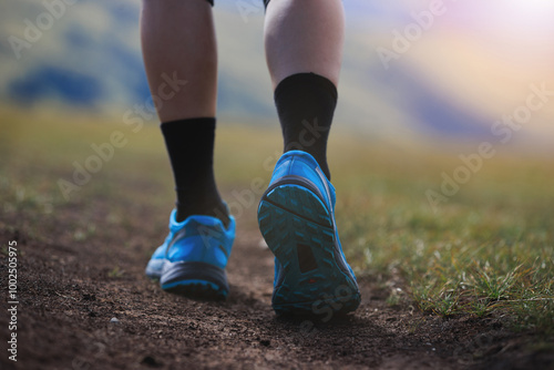 Fitness woman runner running at high altitude grassland mountain top road