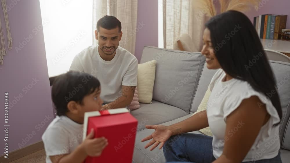 Child holding, gift talking, with woman and man in living room, enjoying family time together in cozy home setting Child holding, gift talking, with woman and man in living room, enjoying family time together in cozy home setting