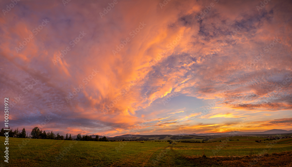 Beautiful,dramatic sky illuminated by the sun during sunset-Panorama