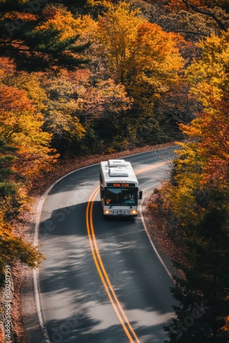 Bus winding through vibrant autumn leaves on a scenic road photo