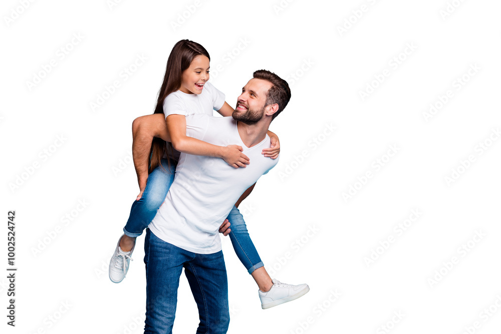 Portrait of cheerful man holding his kid with brunette hairstyle piggyback wearing white t-shirt denim jeans isolated over blue background Portrait of cheerful man holding his kid with brunette hairstyle piggyback wearing white t-shirt denim jeans isolated over blue background