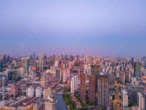 Aerial view of modern city skyline and buildings at sunrise in Shanghai