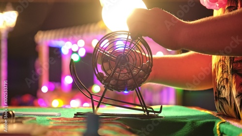 Bingo Game Croupier Picking Random Number Ball from Metal Wheel Cage Roller Shuffler