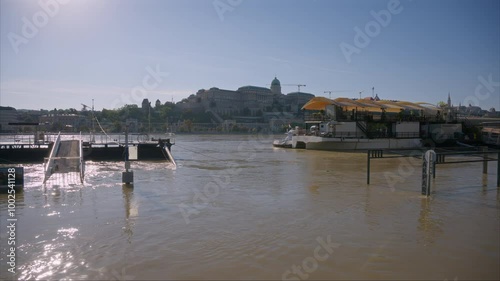 Rakpart in Budapest flooded by the Danube after excessive heavy rains in Central Europe. Floodwaters are covering roads in Hungary. View of Buda Castle during the flood. Water covering the roads. photo