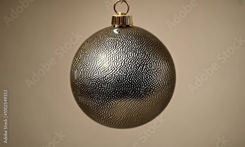 Minimalist and elegant slow motion of a Christmas snake metallic skin textured ball,  clean, tan background, luxury decor inspiration