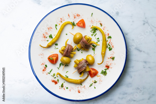 Gilda. Basque tapas pincho with chilli, anchovy and olive. Top view table with  decorations. photo