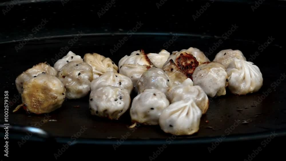 Asian street food fried dumplings being rotated crips and golden brown Asian street food fried dumplings being rotated crips and golden brown