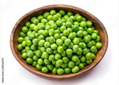 Green peas in a wooden bowl, isolated on white background, view from above