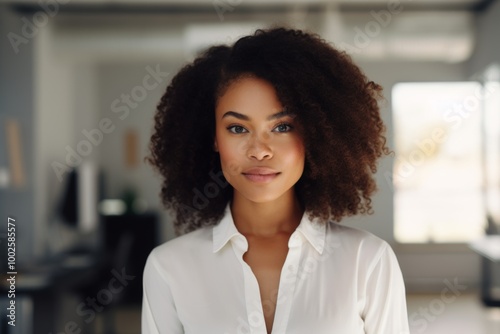 Smiling portrait of a young hipster African American woman in office