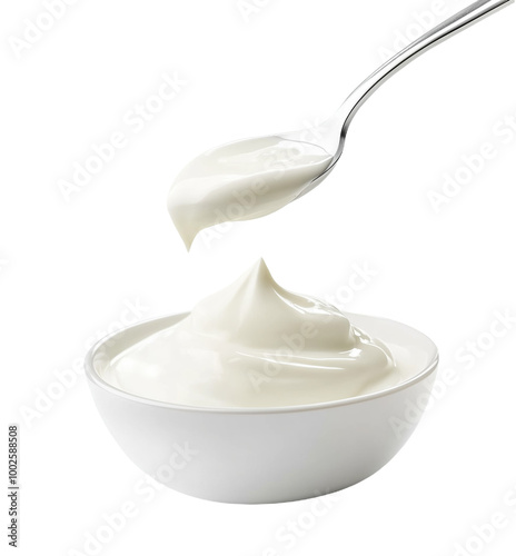 Spoonful of creamy white sour cream gracefully poured into a pristine bowl