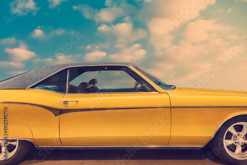Side view of a luxury yellow American coupe car from the seventies