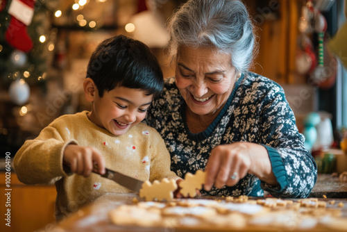 Grandmother and her grandson are smiling and having fun while baking christmas cookies