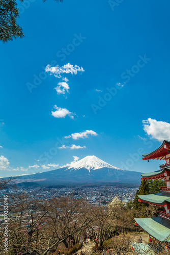 Red pagoda Shimoyoshida shrine with snow on Fuji mountain