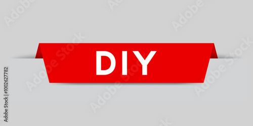 Red color inserted label with word DIY (abbreviation of do it yourself) on gray background