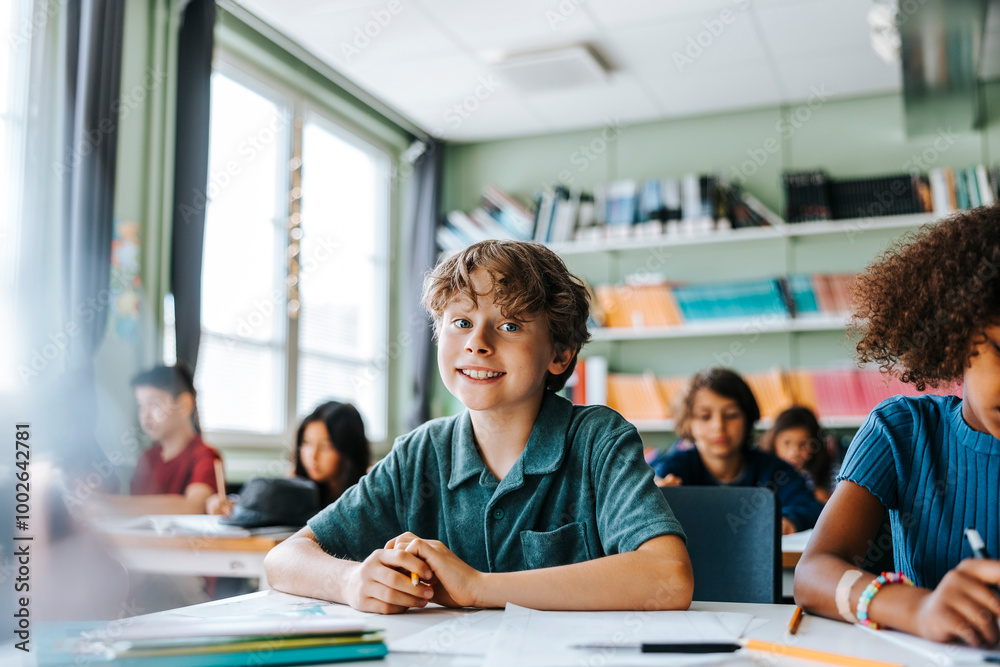 Portrait of cute boy sitting in classroom with classmates at elementary school Portrait of cute boy sitting in classroom with classmates at elementary school