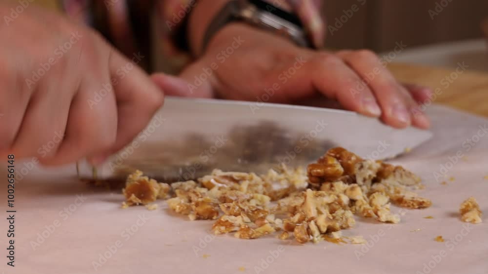 man cuts caramelized nuts with a knife to decorate pumpkin pie man cuts caramelized nuts with a knife to decorate pumpkin pie