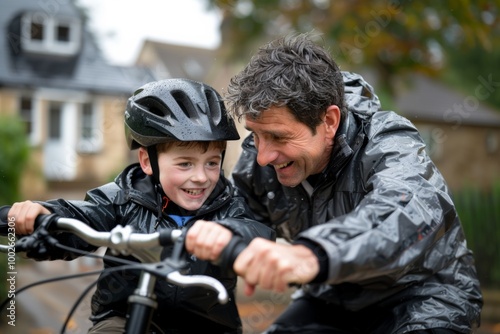 Loving father teaching his son to ride a bicycle in the outdoor