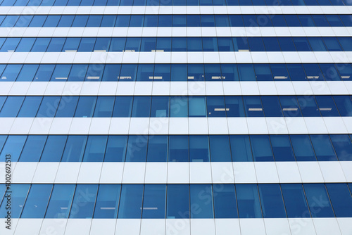 Obraz na płótnie Perspective view from below on office building facade, modern skyscraper. Blue toned glass and steel constructions. Horizontal abstract background, image with place for text. w salonie