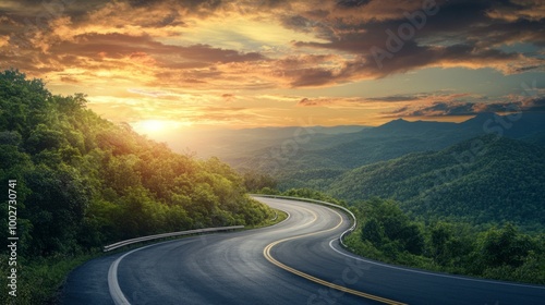 A winding road with a beautiful sunset in the background