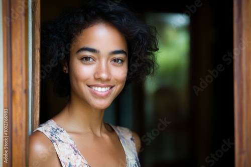 A cheerful African woman welcomes you standing at her door Free Download A cheerful African woman welcomes you standing at her door - GFXLoad