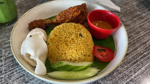 Indonesian fried rice served with chicken rendang. Fried rice asian popular food.