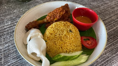 Indonesian fried rice served with chicken rendang. Fried rice asian popular food.