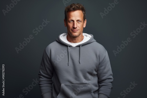 Portrait of a merry man in his 40s dressed in a comfy fleece pullover isolated on blank studio backdrop