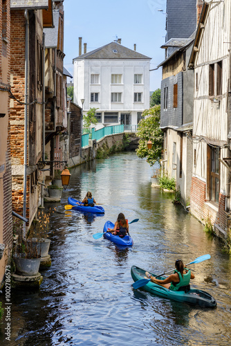 PONT-AUDEMER, NORMANDY, FRANCE: friends paddling on the Risle river, visiting the city from the waterways