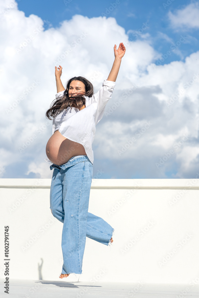 Joyful pregnant woman on the background of the sky. Concept of pregnancy. Joyful pregnant woman on the background of the sky. Concept of pregnancy.