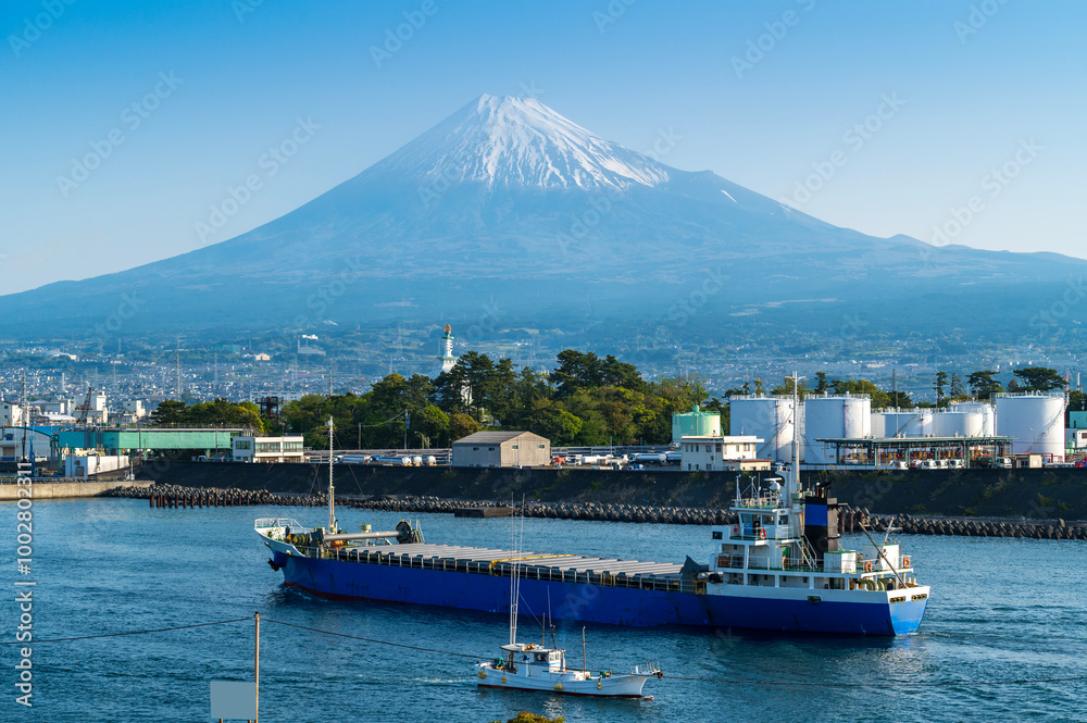 Japan industrial factory area with Fuji mountain and blue sky background view from Fishing port, Fujinomiya City, Shizuoka, Japan.