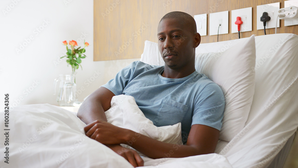 Young Male Patient Lying In Private Hospital Bed Young Male Patient Lying In Private Hospital Bed