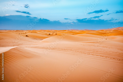 Merzouga, Morocco - Sunrise in desert tour on top of Erg Chebbi dunes and path for camping in the Sahara. Overnight destination in Berber desert camp